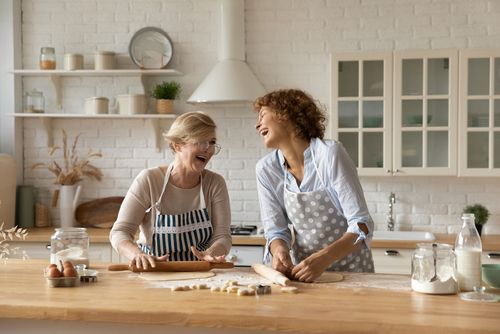 Two Bakers Laughing While Baking