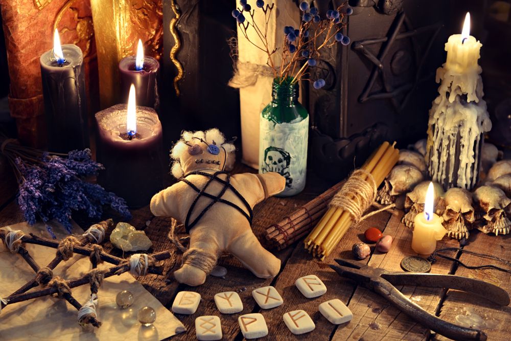 A Voodoo altar with a doll and candles