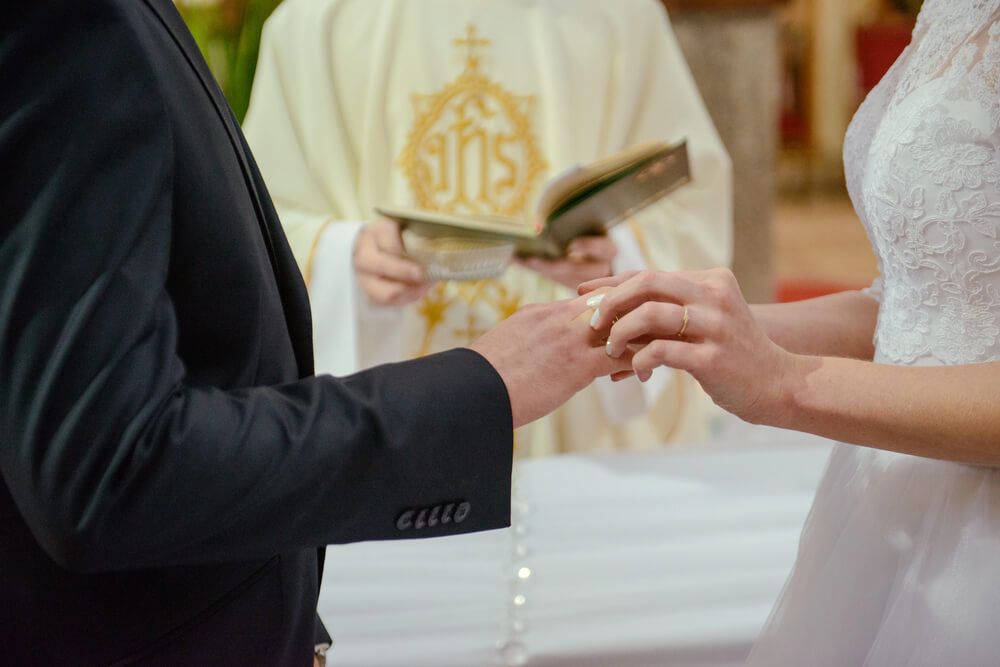 A couple standing in front of an wedding officiant