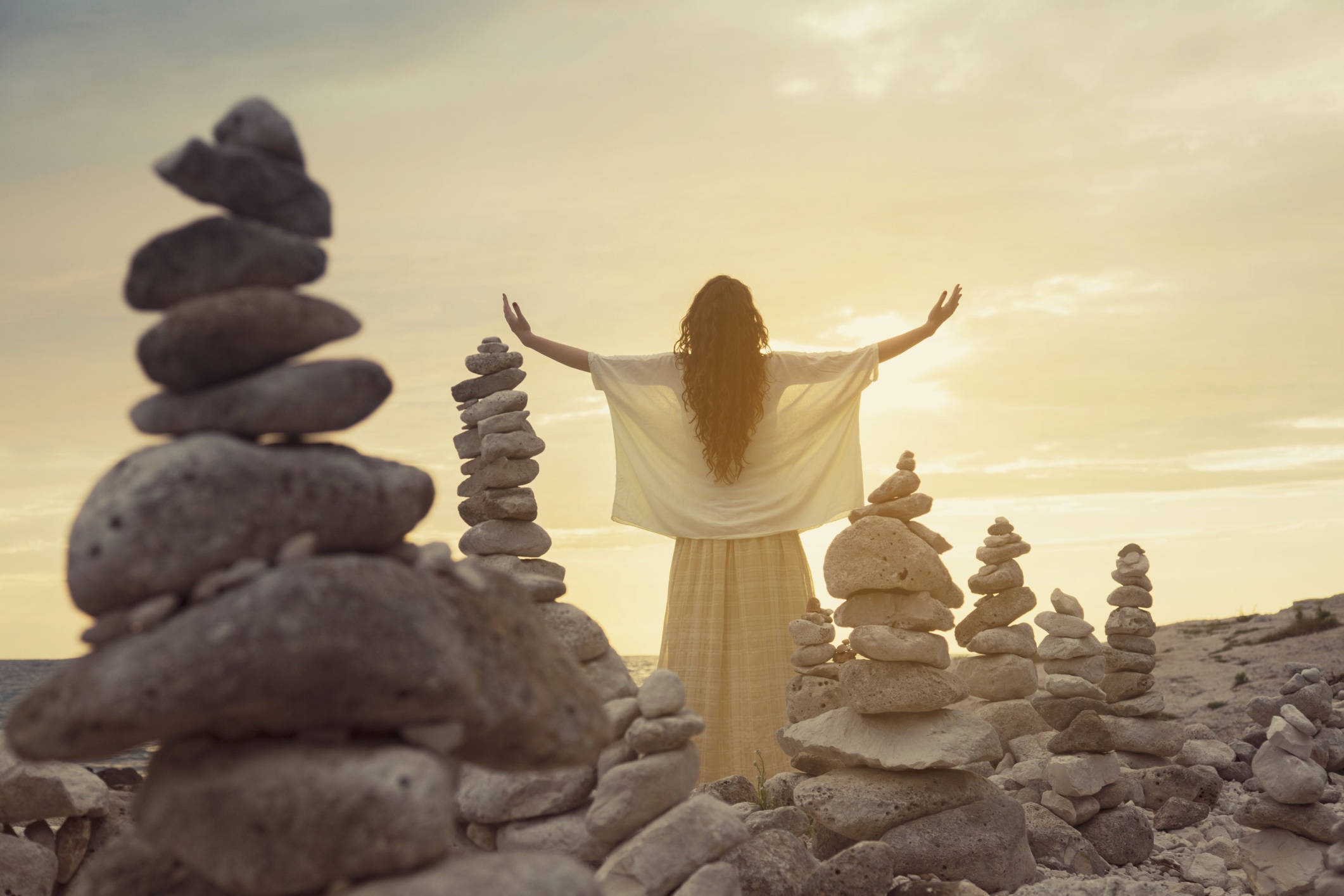 Woman standing by rocks