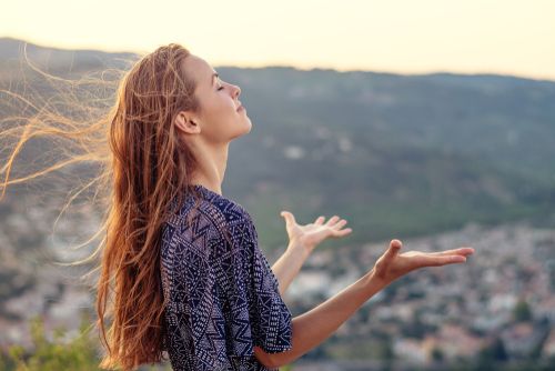 A spiritual woman embracing one of the world's religions