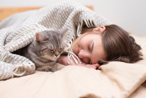 Woman in Bed With Her Cat