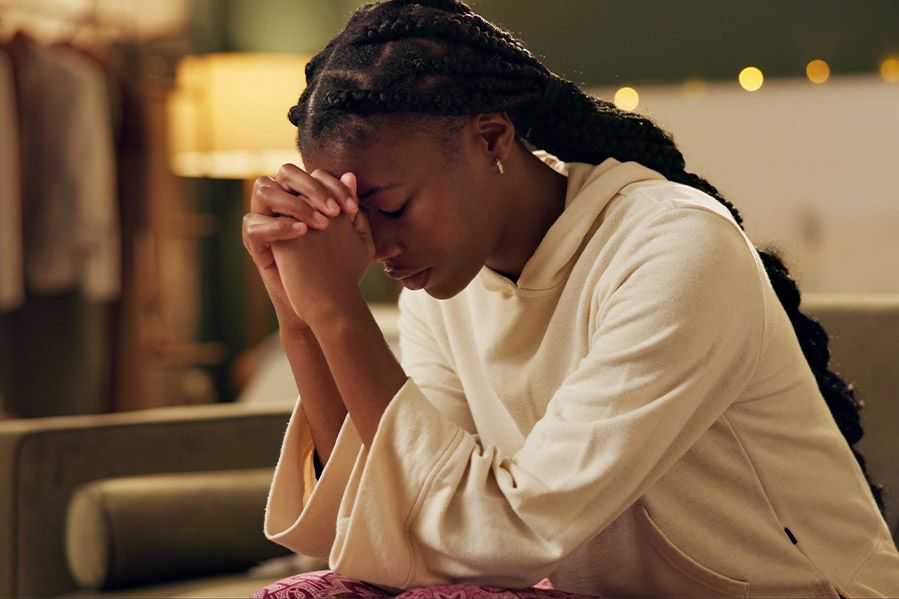woman praying in her home