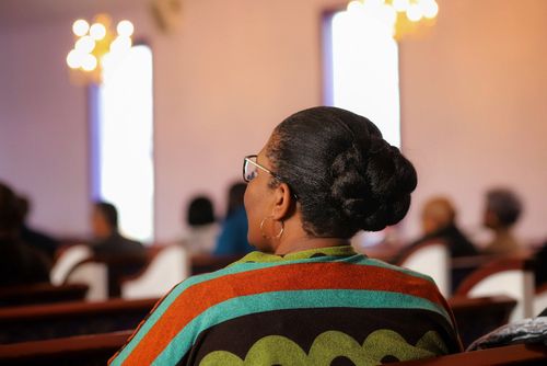 Woman Sitting in a Church