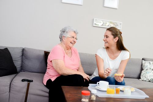 Young Woman Visiting With Elderly Woman