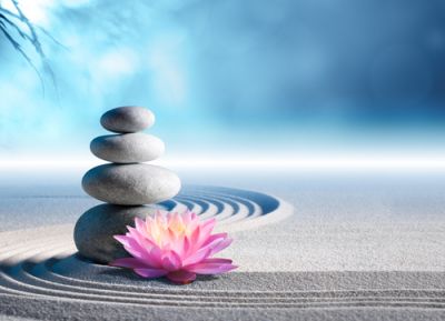 A zen garden with stones stacked in the sand