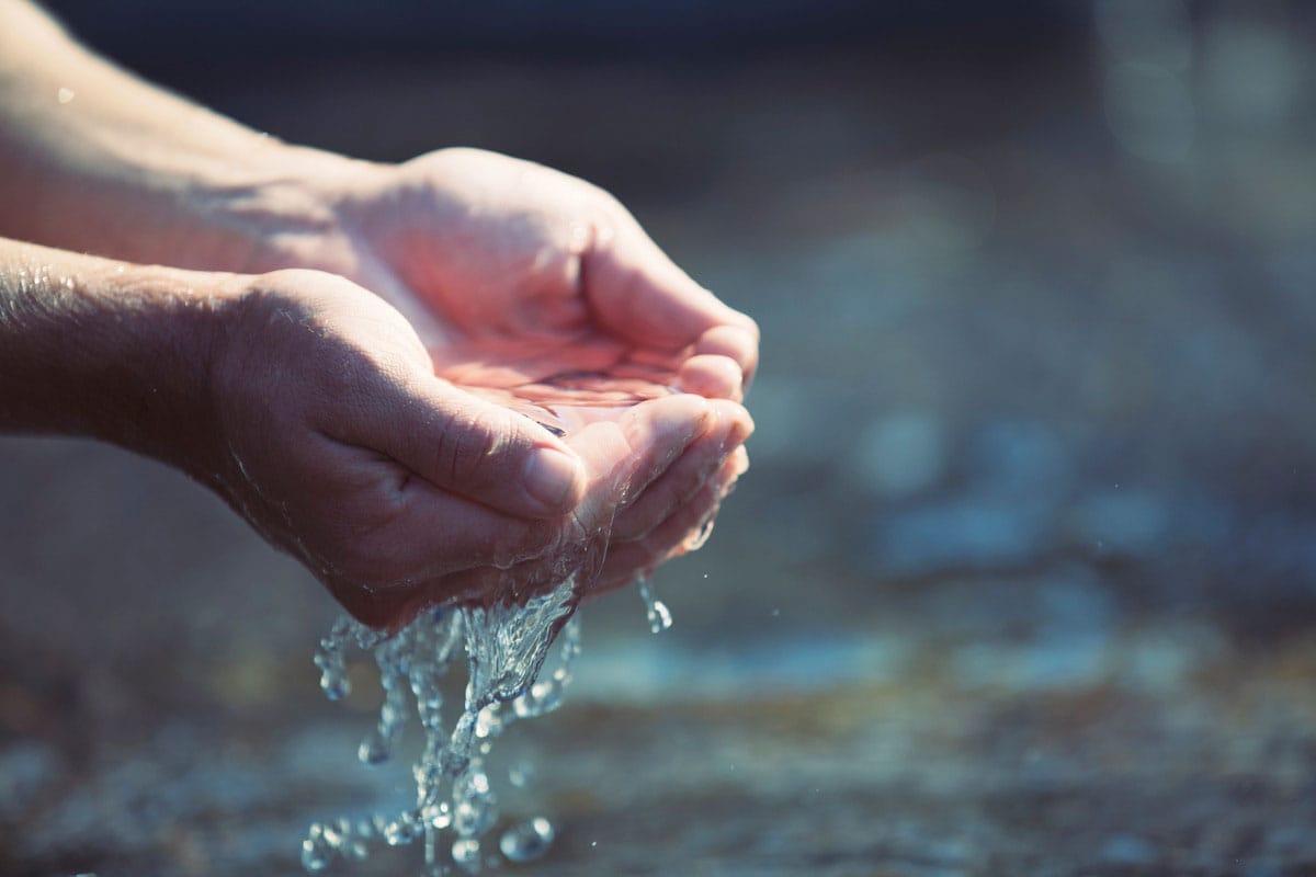 Hands holding baptism water