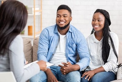 Wedding officiant discussing wedding with couple