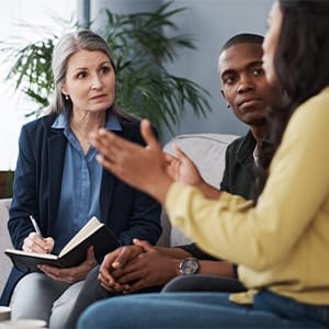 A therapist is having a session of couple's therapy with her clients