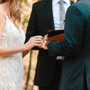 An up-close view of a ring exchange happening at a couple's wedding ceremony