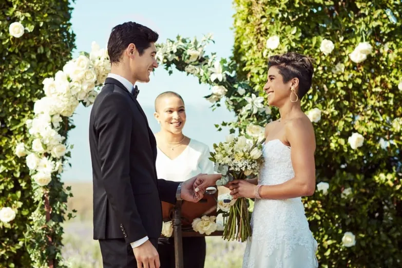 A wedding ceremony in an outdoor garden, the couple is getting married
