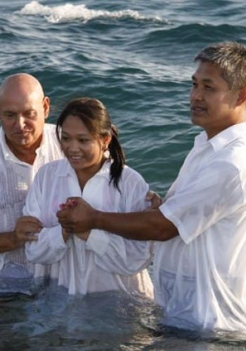 Performing a baptism in a river