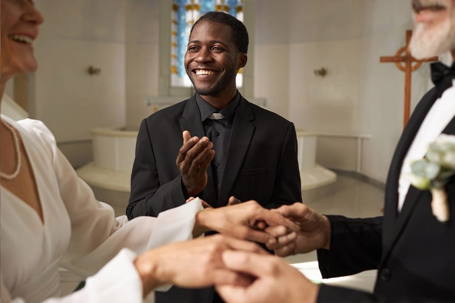Minister smiling as he officiates a marriage