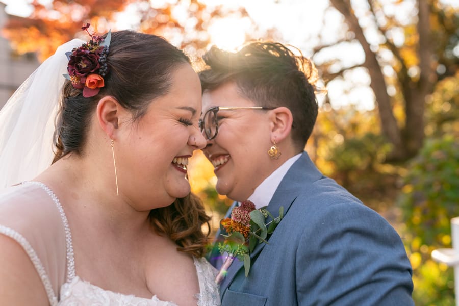 Brides showing wedding rings at gender neutral wedding ceremony