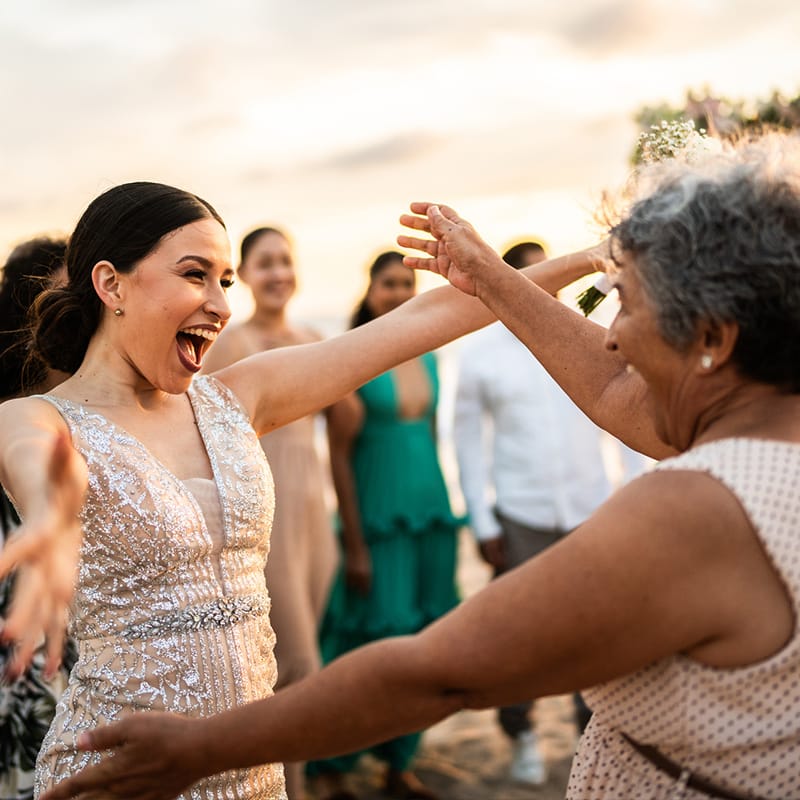 Two ladies about to embrace after celebrating the union of their families.