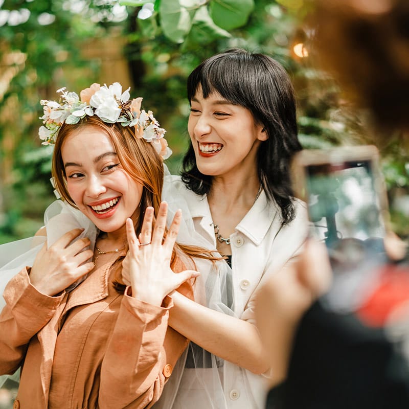 One of the brides is showing off her ring after becoming a newlywed.