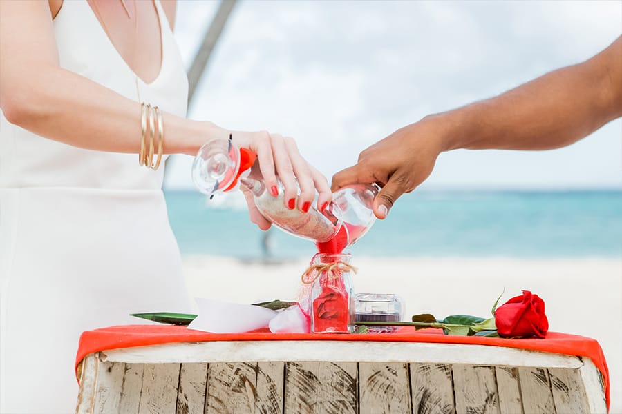 Bride and groom pouring sand during wedding ceremony